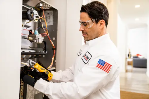 One Hour Air Conditioning Tech, Carlos, working on a furnace in a Miami home