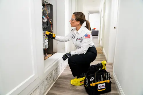 One Hour AC Tech Denise working on a HVAC Furnace inside a home in Miami FL